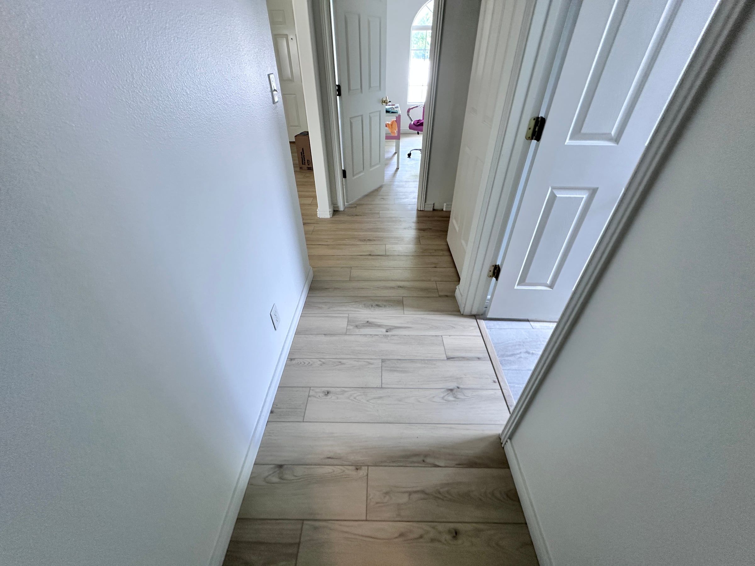 Luxury vinyl plank in a hallway leading to bedrooms